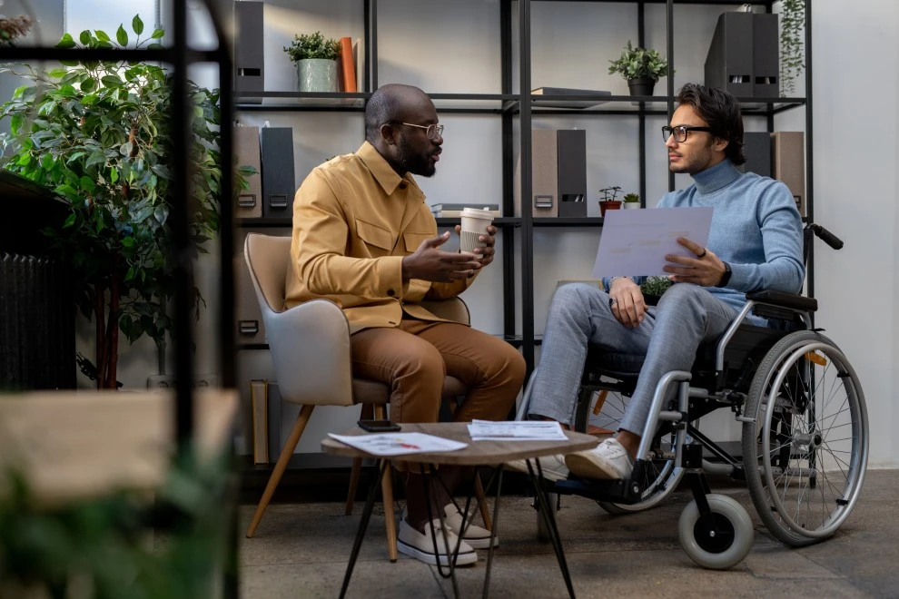 Support Coordinator talking with disabled man in wheelchair